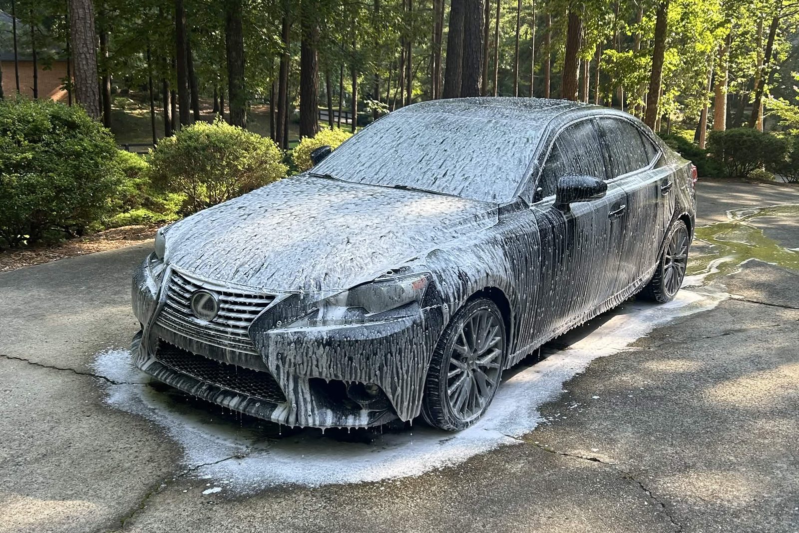 Black Lexus covered in snow foam during a mobile detail in Woodstock, GA